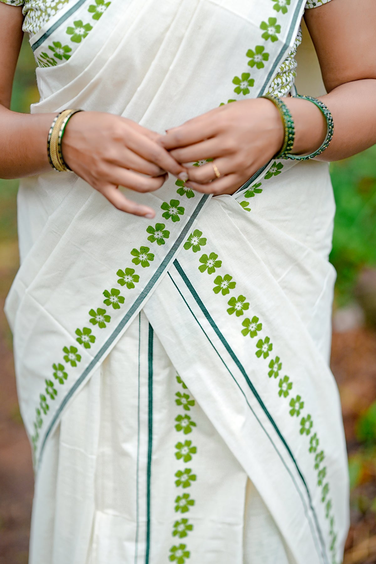 Arunima -Green Floral Printed Puliyilakkara Settumund with Matching Floral Blouse Material