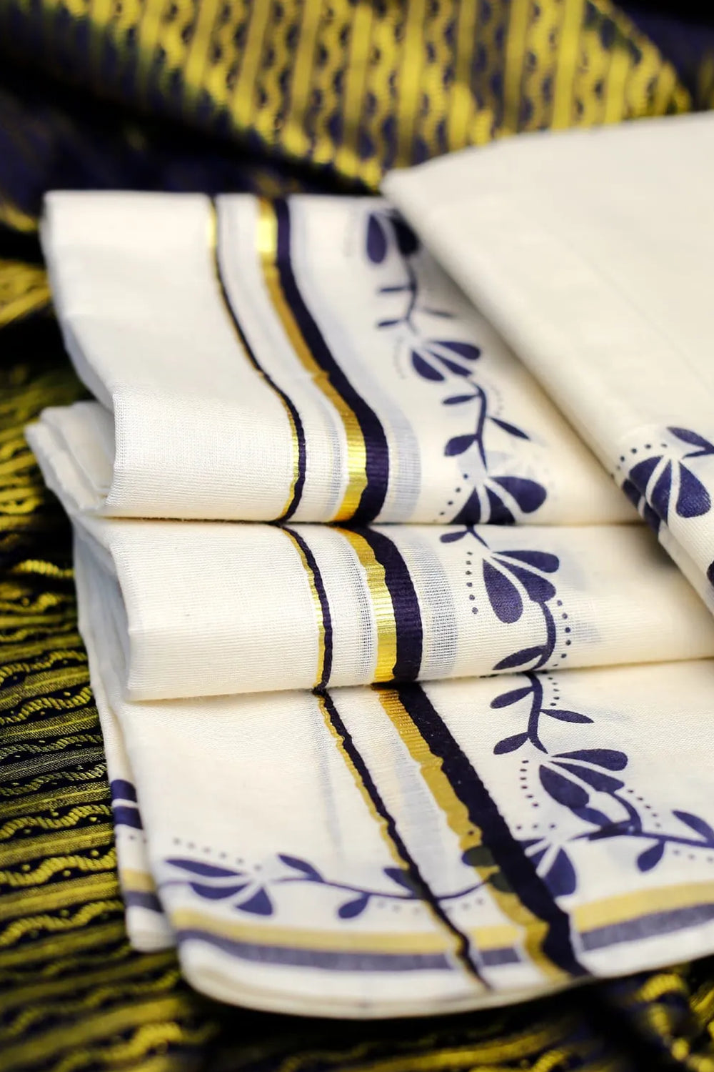 Nithya – Dark Navy and Golden Kasav Puliyilakkara Settumund with Printed Border and Brocade Blouse Material
