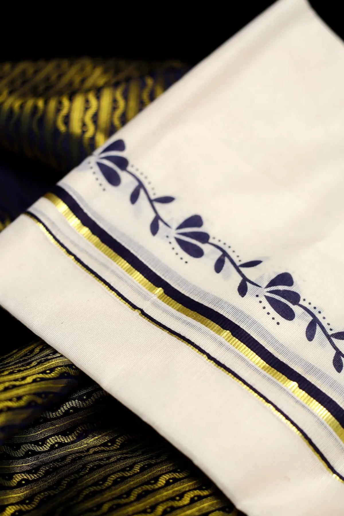 Nithya – Dark Navy and Golden Kasav Puliyilakkara Settumund with Printed Border and Brocade Blouse Material