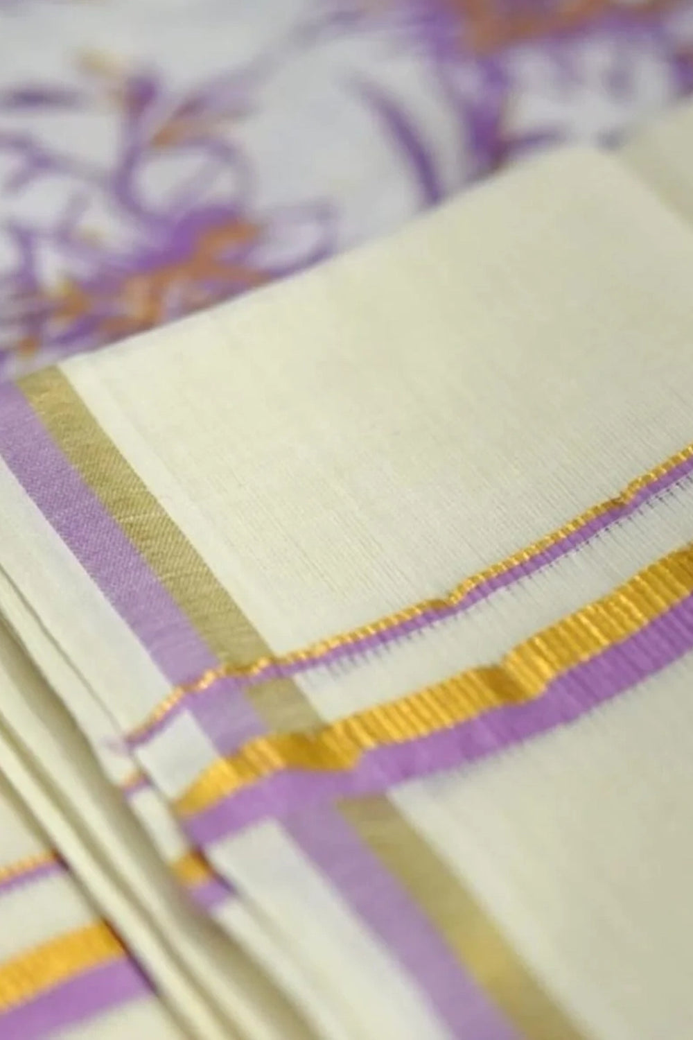Vaikha – Lavender and Golden Kasav Puliyilakkara Settumund with Floral Printed Blouse Material