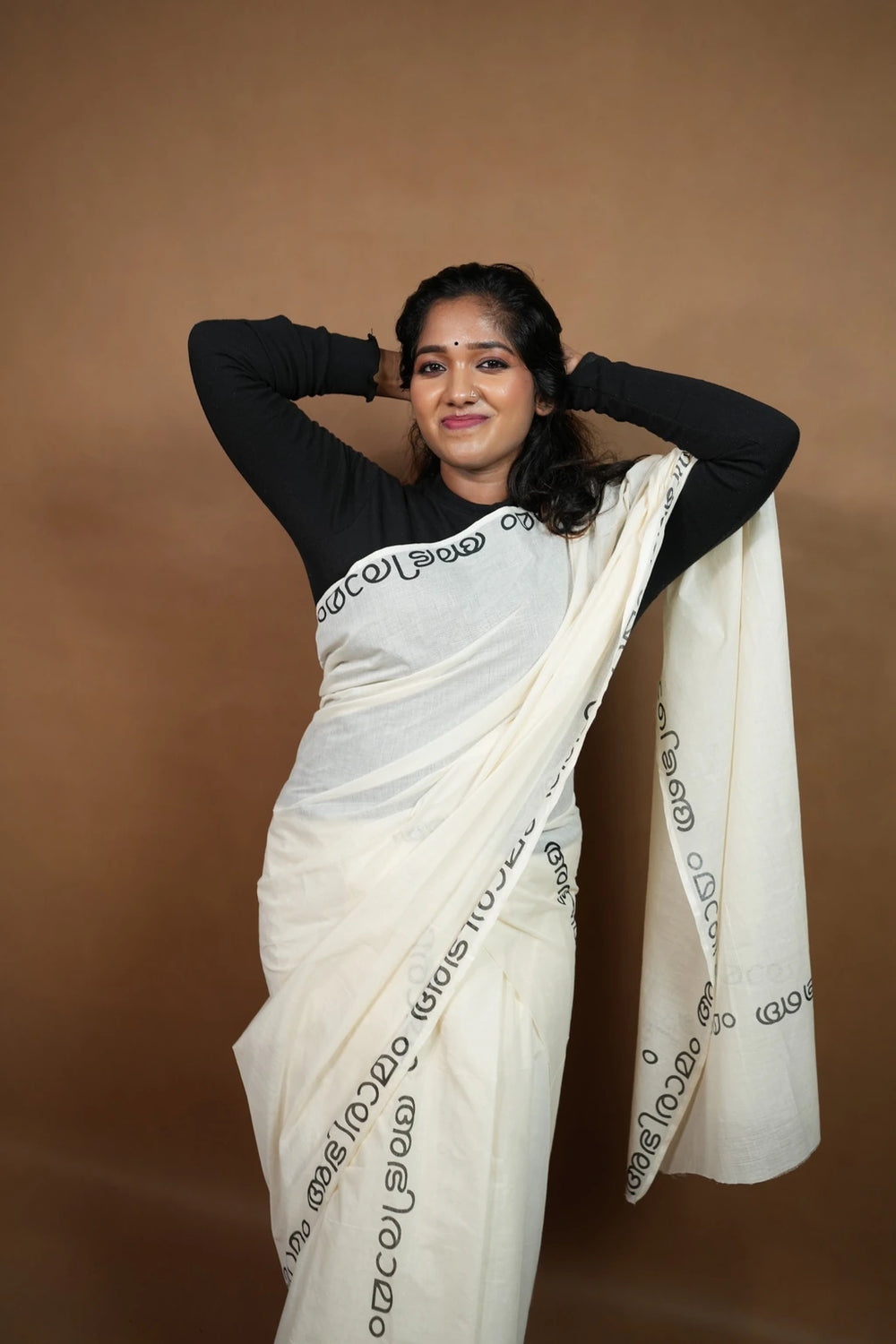 Model wearing Abhiramam Printed Settumund with black printed border