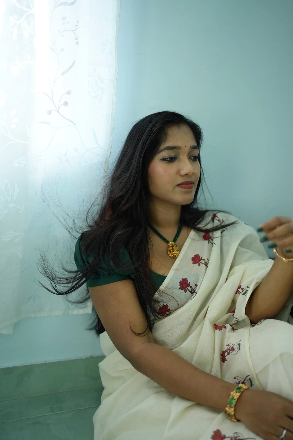 Padma Hasta Green Settumundu with matching blouse material, seated portrait