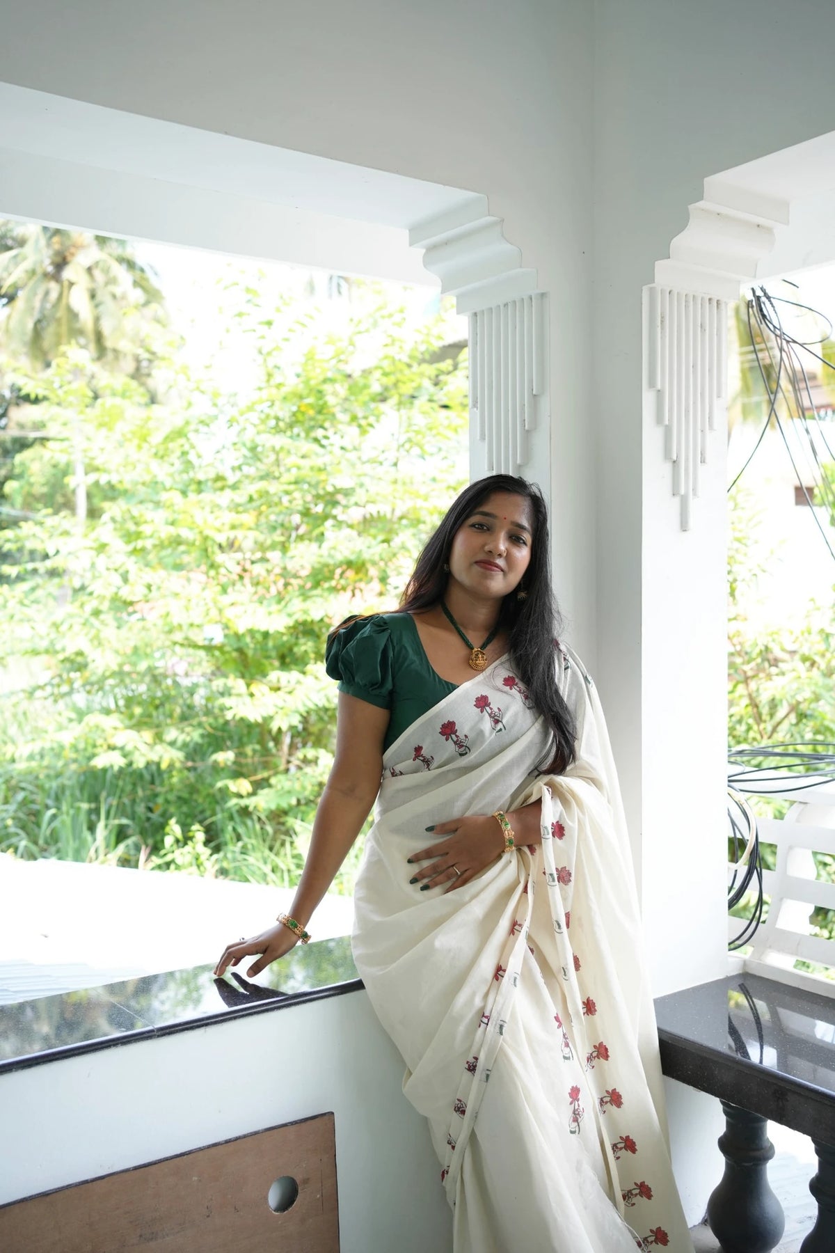 Padma Hasta Green Settumundu with matching blouse material, standing full-length look