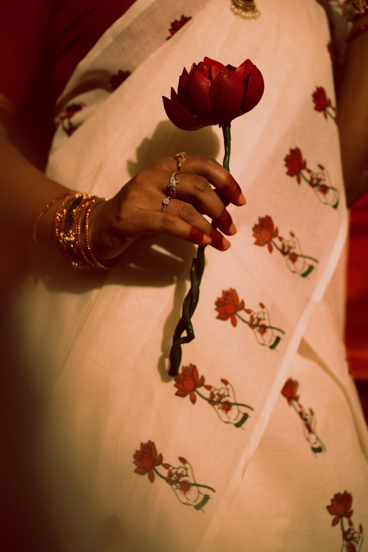 Padma Hasta Red Settumundu with matching blouse material, floral fabric detail with red lotus