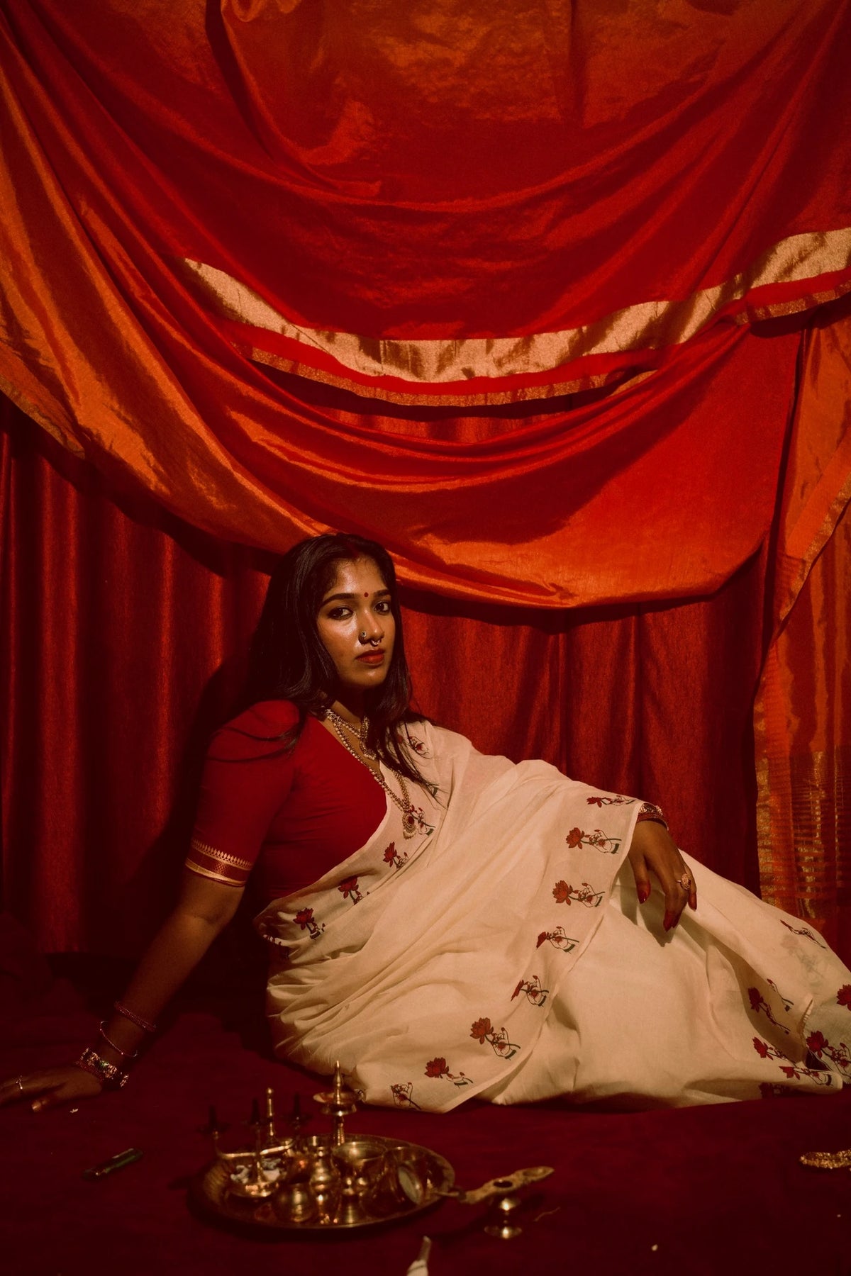 Padma Hasta Red Settumundu with matching red blouse, traditional editorial look
