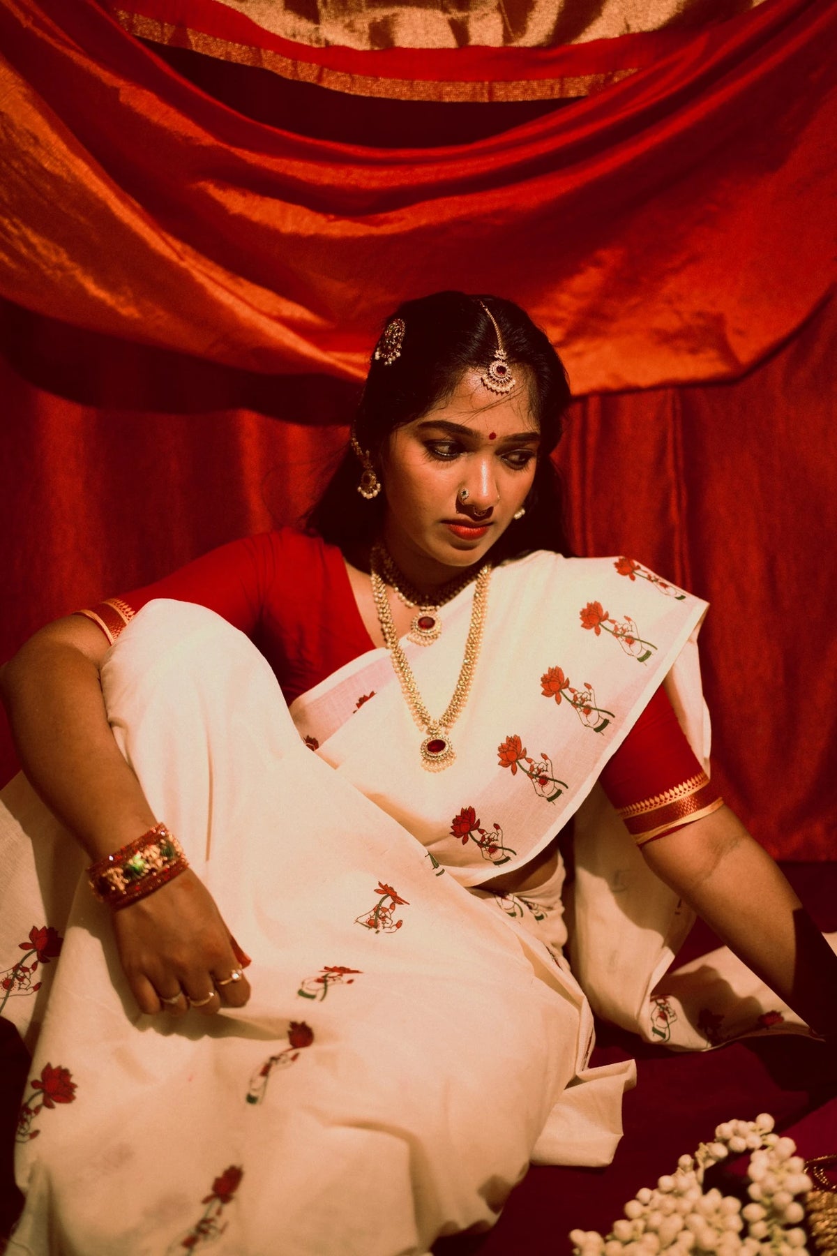Padma Hasta Red Settumundu with matching blouse material, seated portrait