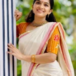 Chendumalli – Yellowish Orange and Golden Kasavu Settumund with Designer Blouse Material